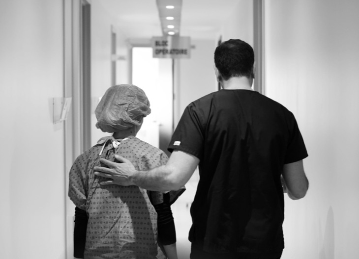 Two team members walking down a hallway from behind