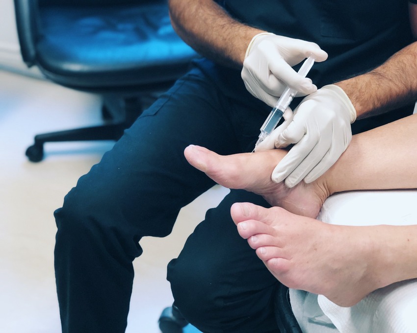 Doctor injecting into a foot