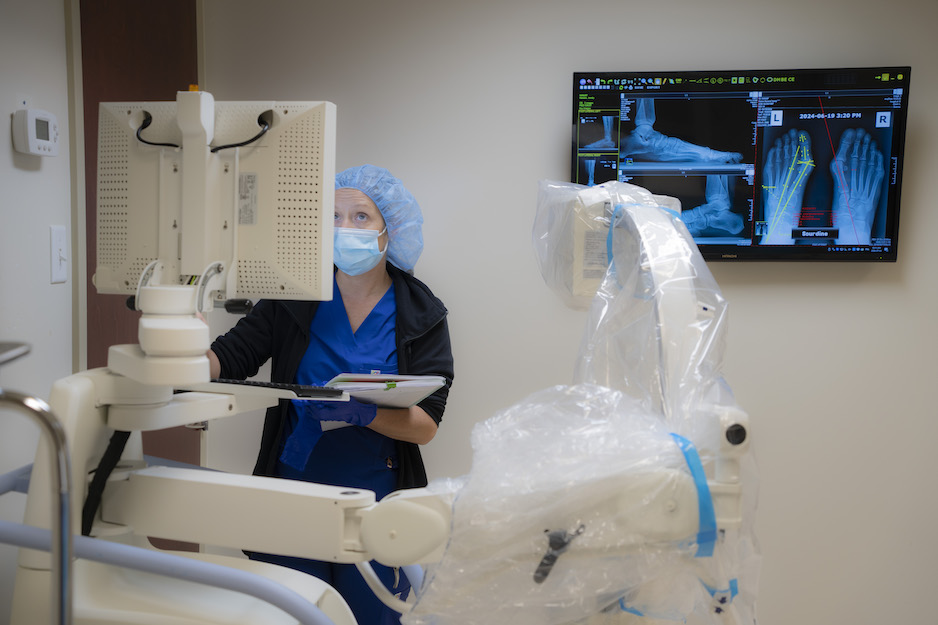 A doctor looking at a patient's file on a computer