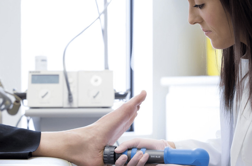 Doctor administering shockwave therapy